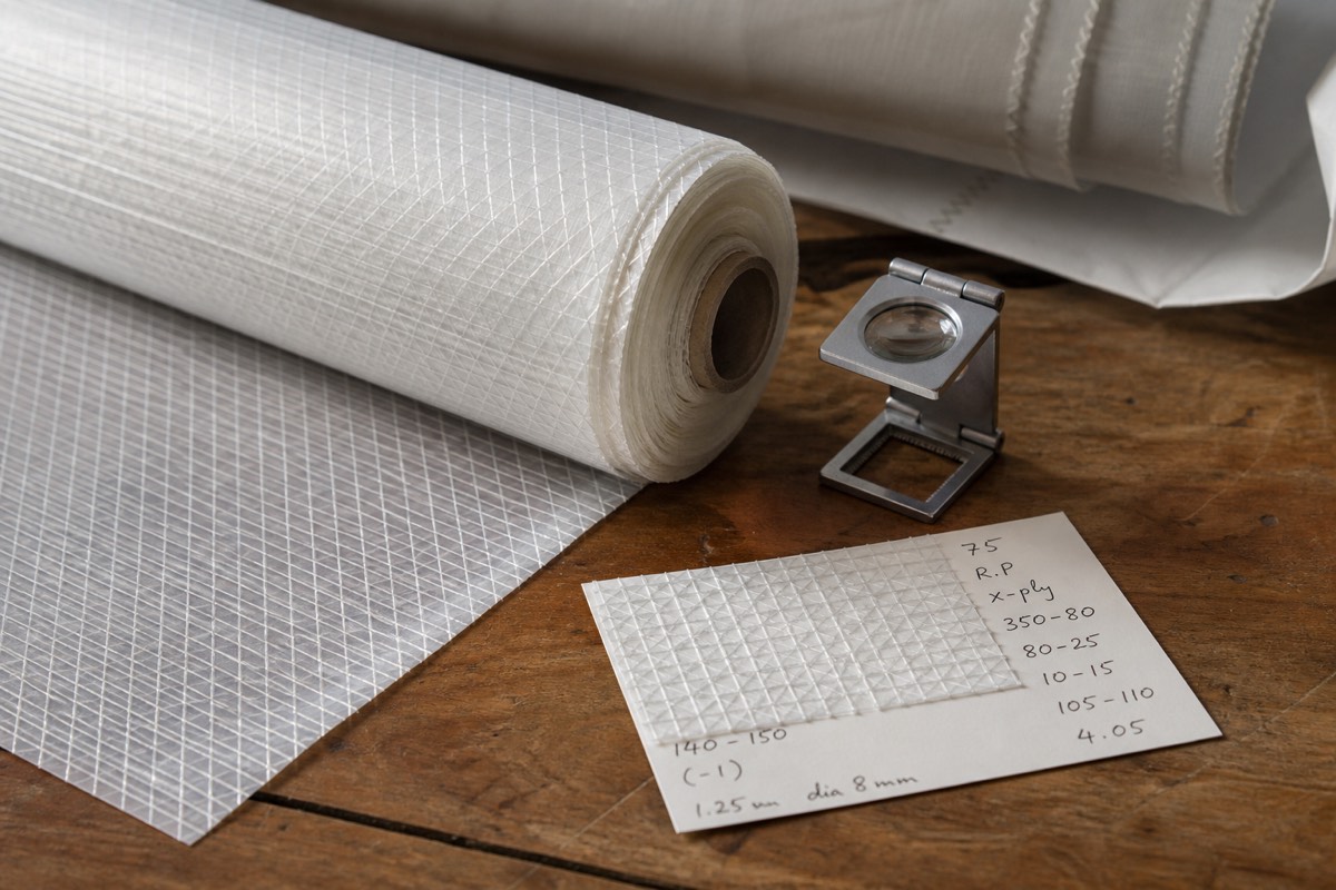 A sailcloth sample roll, a fabric scale and a handwritten measurement card